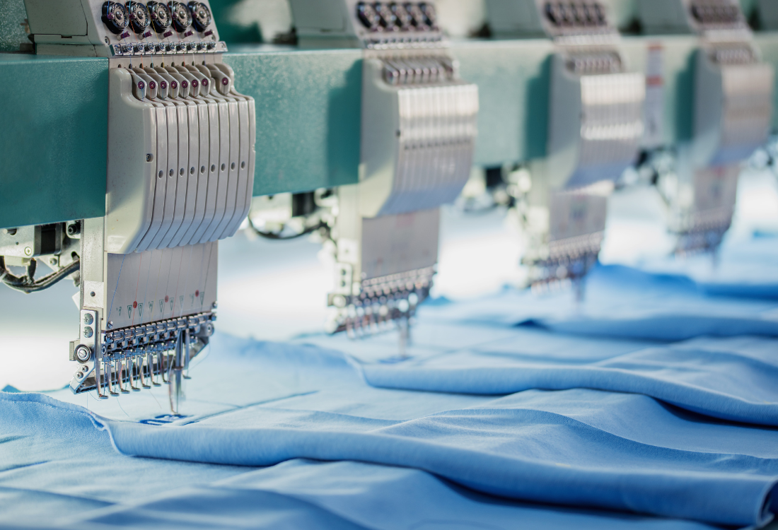 Industrial embroidery machines implementing a logo on a bulk workwear order. 